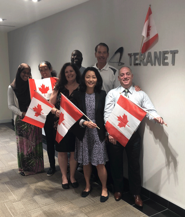Teranet group holding Canadian flags