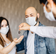 Couple receiving home keys from a real estate broker